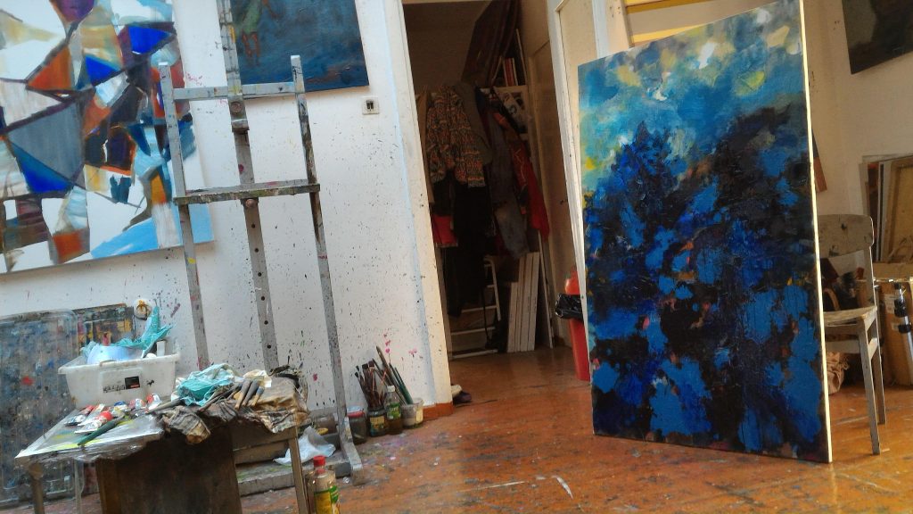 in the studio, checking composition of painting