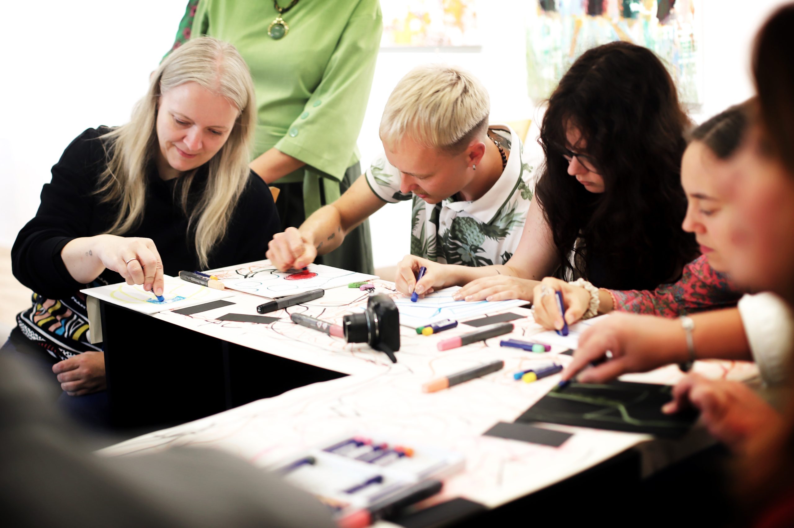 Participants drawing together with oil pastels