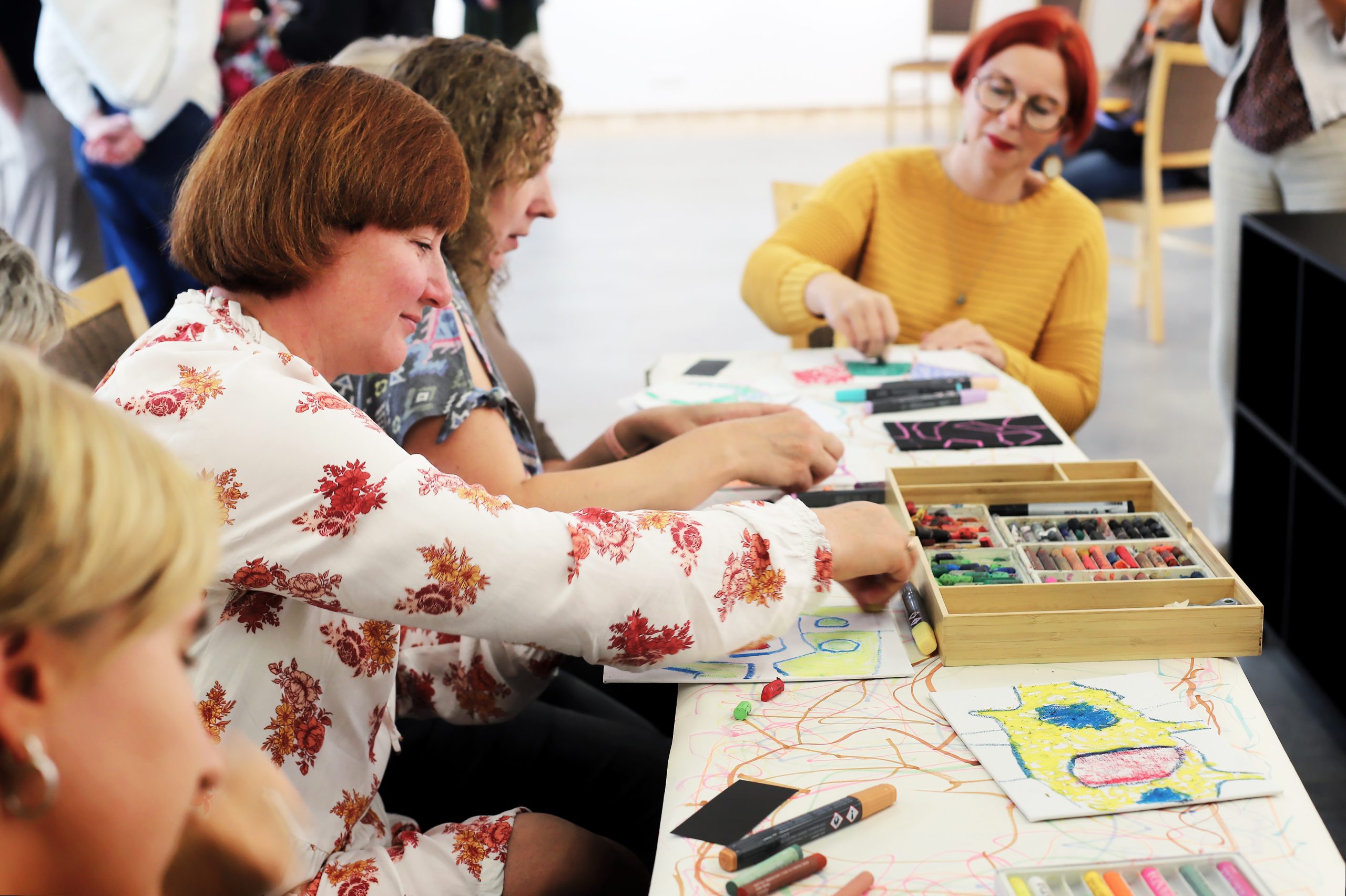 Participants drawing around a shared table